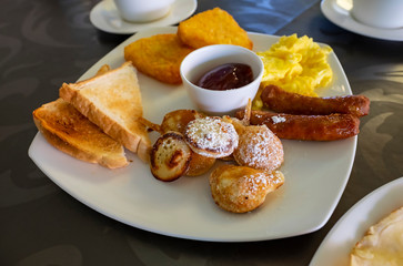Sweet Dutch Pancakes Served with Sausages, Scrambled Eggs, Toasts and Hash Browns