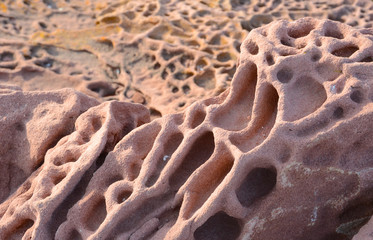 textured red rocks in sardinia, italy