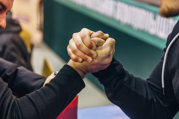 Two men competing in arm wrestling