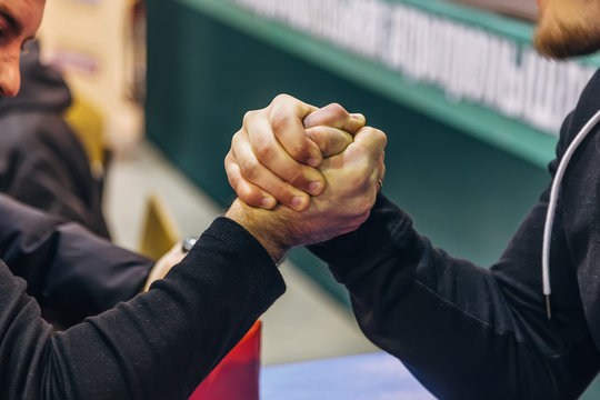 Two Men Competing In Arm Wrestling