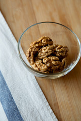 Walnuts in glass bowl, low angle view.
