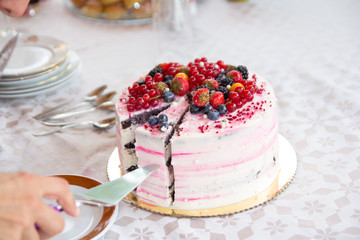 hand serving birthday cake