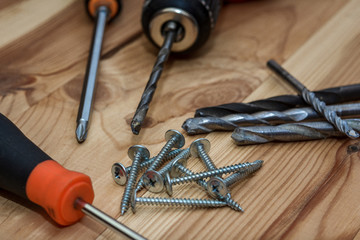 Drill and set of drill on wooden table. set of tools for the home master.