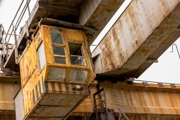 Fototapeta premium Elevator on rails to control a lifting winch with a steel cable and hook for loading and transportation