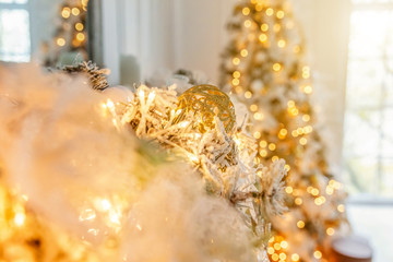 Classic Christmas decorated New year fireplace. Christmas tree with gold decoration element ball. Modern classical style interior design apartment. Christmas eve at home
