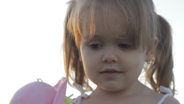 Adorable nice little child smling having positive mood looking at camera funnily