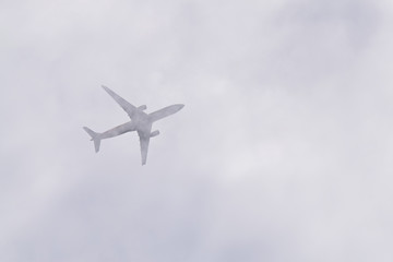 Fototapeta na wymiar Airplane in the Clouds