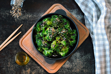 Broccoli baked in a cast iron skillet. Healthy Chinese style food. Vegan snack. Food sticks. Serve...
