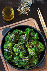 Broccoli baked in a cast iron skillet. Healthy Chinese style food. Vegan snack. Food sticks. Serve...