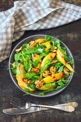 Healthy food bowl. Salad with arugula, pear and walnut. Vegan bowl of colorful salad.