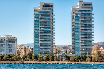 Limassol sea front with high rise residential buildings and pedestrian walkway. Cyprus