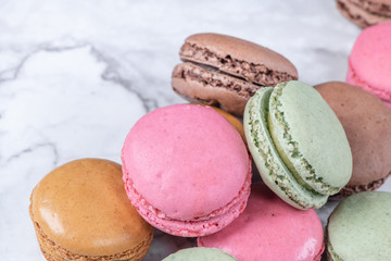 Colorful macaroons on stone table. Sweet macarons