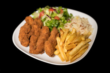 Chicken Goujons served with rice, salad and french friends on plate