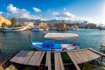 Tiny old boat moored in Kyrenia harbor. Cyprus - obrazy, fototapety, plakaty