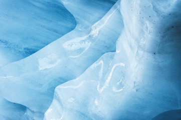 Close-up the ceiling of an ice grotto in a crumbling glacier. Textured background. Global warming. Small DOF