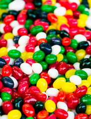 Fototapeta na wymiar Colorful candies texture background. Rainbow colorful candy coated chocolate pieces in a bowl (selective focus)