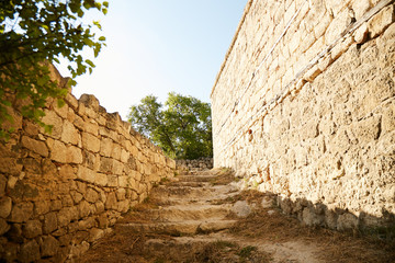 An ancient city on the peninsula of Crimea. A staircase along the fence made of natural stone.