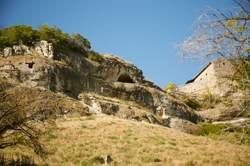 Fototapeta na wymiar Rocky terrain and old stone buildings.