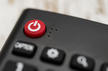 Close up macro photography of a smart tv television remote control with power button. Concept of entertainment, fun, and news