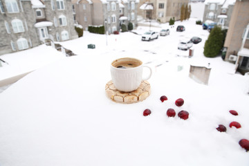 cup of coffee in the snow against the background of the street