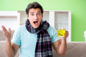 Young handsome man suffering from illness at home 