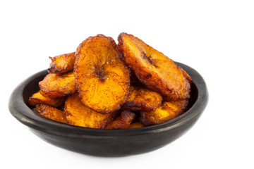 Deep fried ripe plantain slices isolated in white background © anamejia18