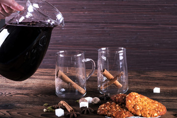 Decorated composition of mulled wine in glasses on wooden table