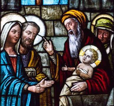 Casorate Primo, Italy. 2017/12/8. A stained glass window depicting Feast of the Presentation of Our Lord Jesus and the the Purification of the Blessed Virgin Mary in the church of San Vittore Martire.