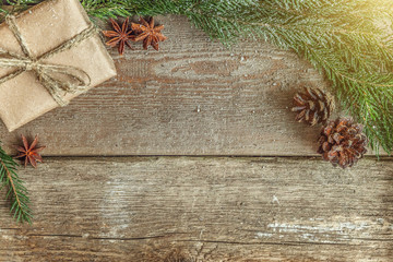 Christmas New Year composition with gift box fir branch pine cones anise on old shabby rustic wooden background. Xmas holiday december decoration to Russian tradition. Flat lay, copy space