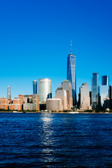 Skyline of downtown Manhattan over Hudson River under blue sky, at sunset, in New York City, USA
