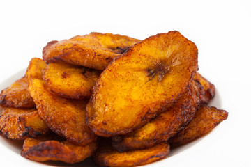 Deep fried ripe plantain slices isolated in white background - obrazy, fototapety, plakaty