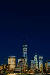 Night view of skyline of downtown Manhattan under dark blue sky, in New York City, USA
