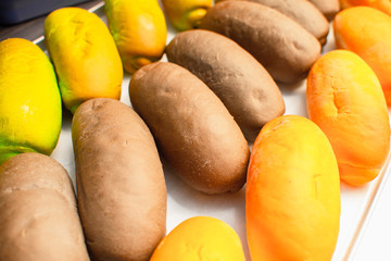 Multicolored buns for hot dogs on a close-up table