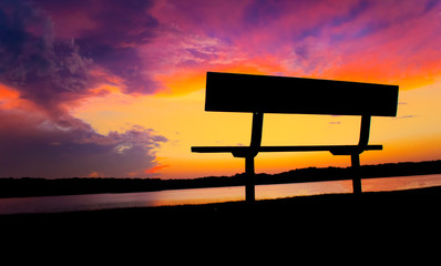 Rare Spectacular Cloud Formations During Sunset Over Calm Lake Waters And Relaxing Bench