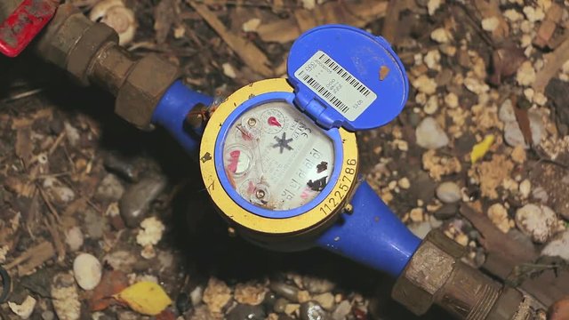 Water meter in the ground hole. Measure the flow of water. Professional water flow meter in the ground hole