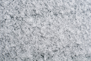 New snow lay on dark surface