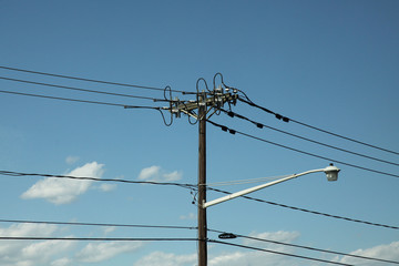 High electricity pole line in blue sky
