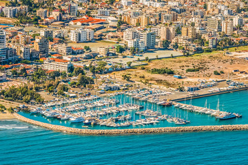 Sea port city of Larnaca, Cyprus. View from the aircraft to the coastline, beaches, seaport and the architecture of the city of Larnaca.