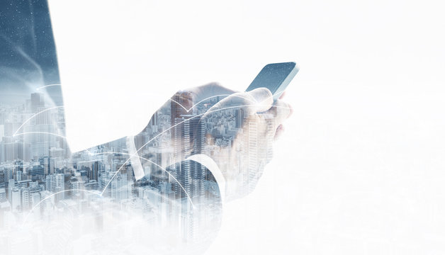Double exposure businessman using mobile smart phone, and network connection technology in the city. Business network, blockchain technology and internet connection
