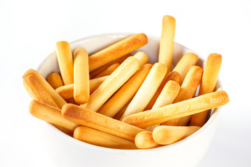 bread sticks on bowl on white background.