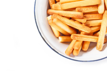 bread sticks on bowl on white background.