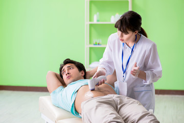Young man visiting radiologyst for ultrasound procedure 