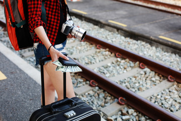 close up traveler carry camera, luggage , wallet standing await train at train station