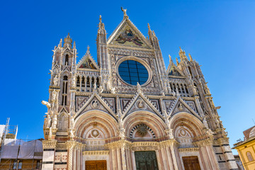 Fototapeta na wymiar Facade Towers Mosaics Cathedral Siena Italy