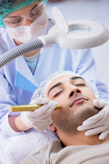 Man visiting dermatologyst for laser scar removal  
