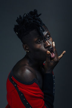 Portrait of a male African American model with his hands pressing on his lips