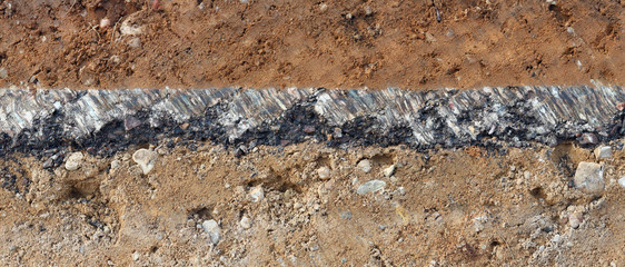 Cross-section of the pavement with layers of clay sand and asphalt