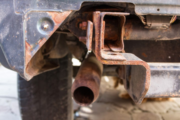 rusty car exhaust pipe on an old SUV