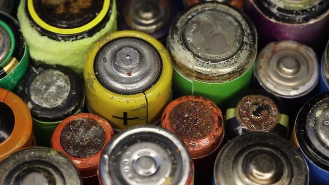 Old Rusty Alkaline Batteries. Waste, collection and recycling, high danger for the environment