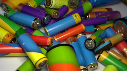 Old used and corroded domestic batteries. To Dispose of Batteries. Waste, collection and recycling - Powered by Adobe